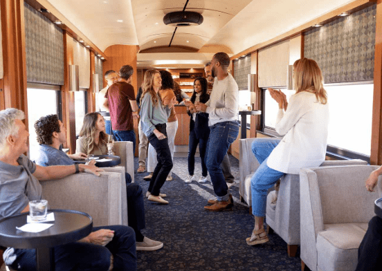 Guests socializing in the Rocky Mountaineer lounge car